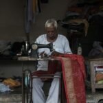 man using sewing machine